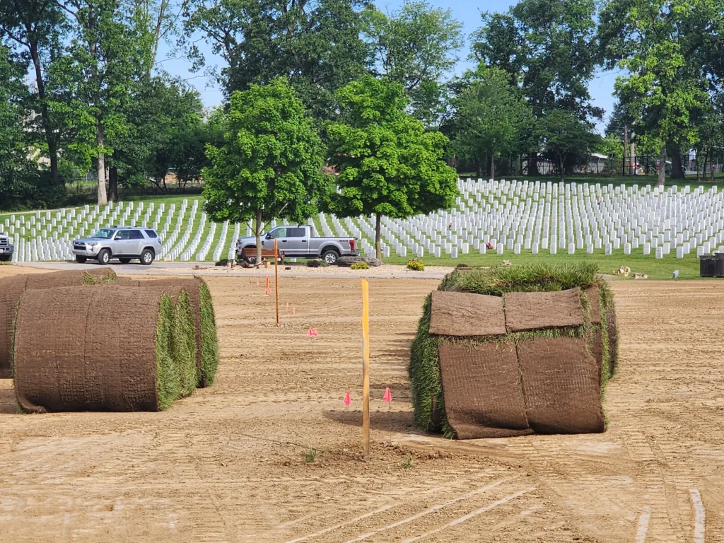 Rolls of new sod on prepared dirt, ready to be rolled out at Jefferson Barracks National Cemetery Sec 1KK.